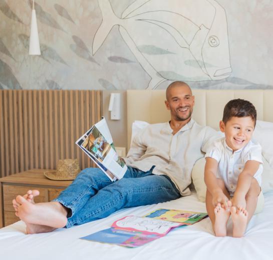 Modern room with double bed, sofa, and marine decorations.